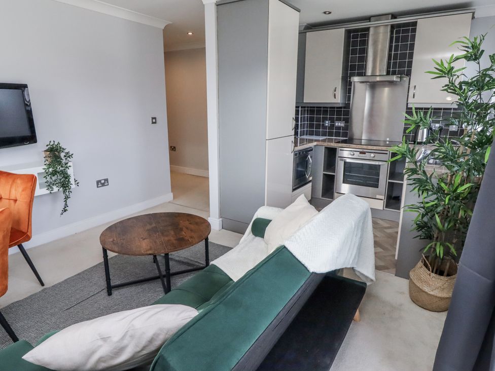 A living room with a sofa and coffee table at 16 The Viking in Seahouses