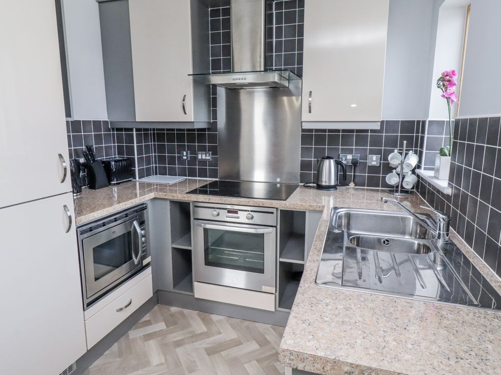 A kitchen with oven and sink at 16 The Viking Seahouses