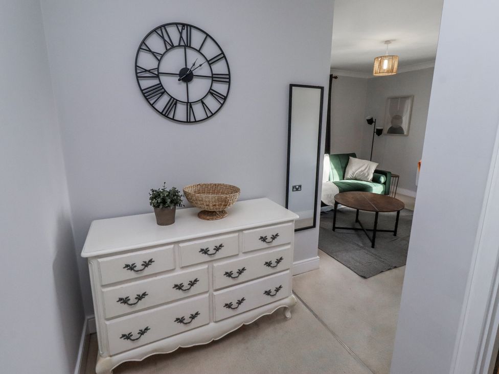 A hallway with a dresser and mirror at 16 The Viking in Seahouses