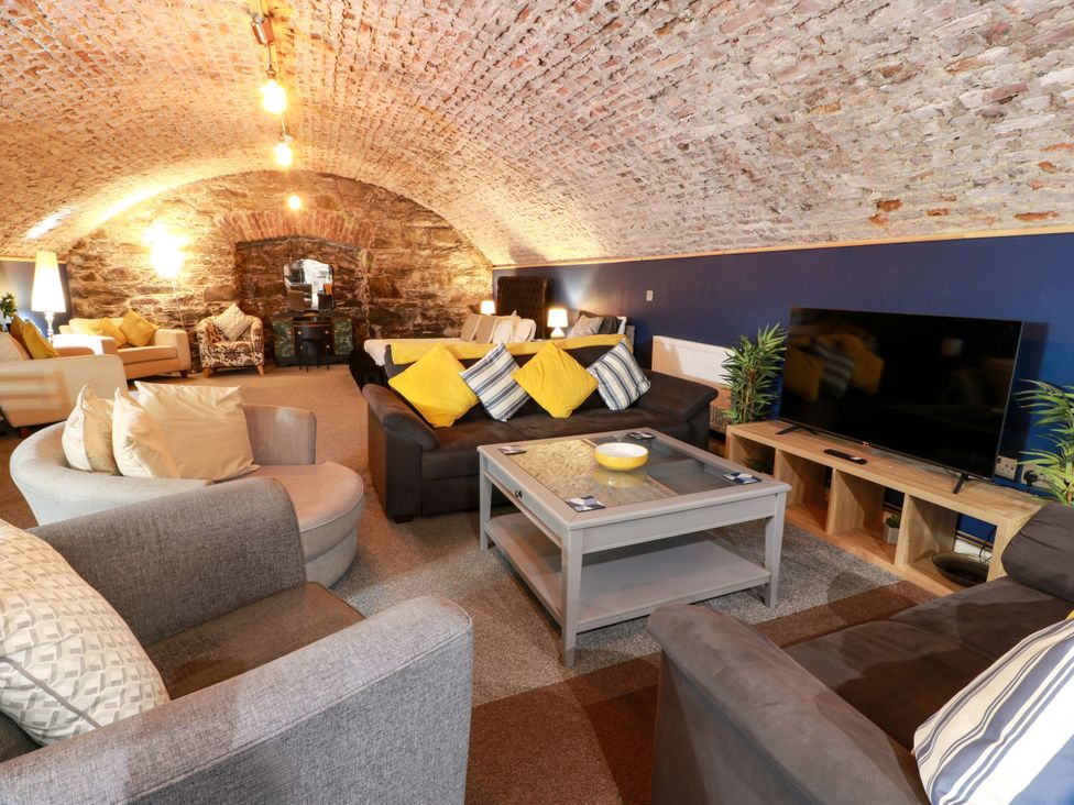 A living room with a coffee table and sofa at 69 High Street Gatehouse Of Fleet