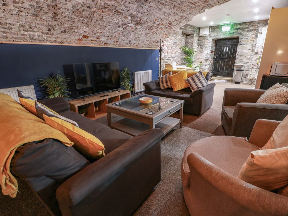 A living room with a television and seating area at 69 High Street Gatehouse Of Fleet