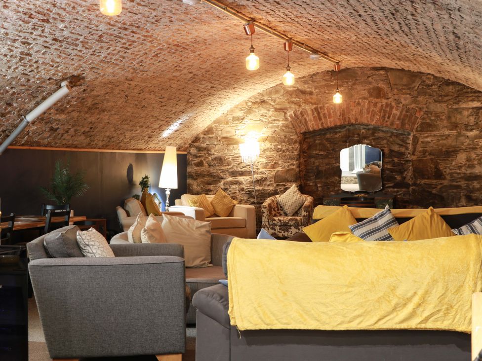 A snug area with seating and a table at 69 High Street Gatehouse Of Fleet