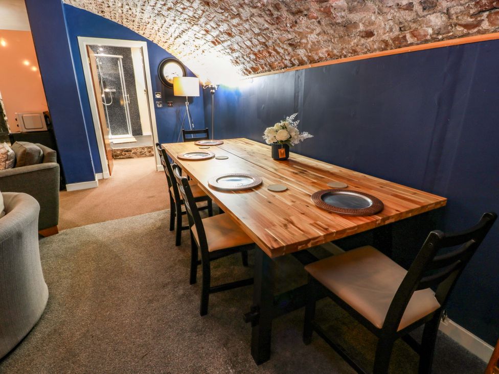 A dining room with a table and chairs at 69 High Street in Gatehouse Of Fleet