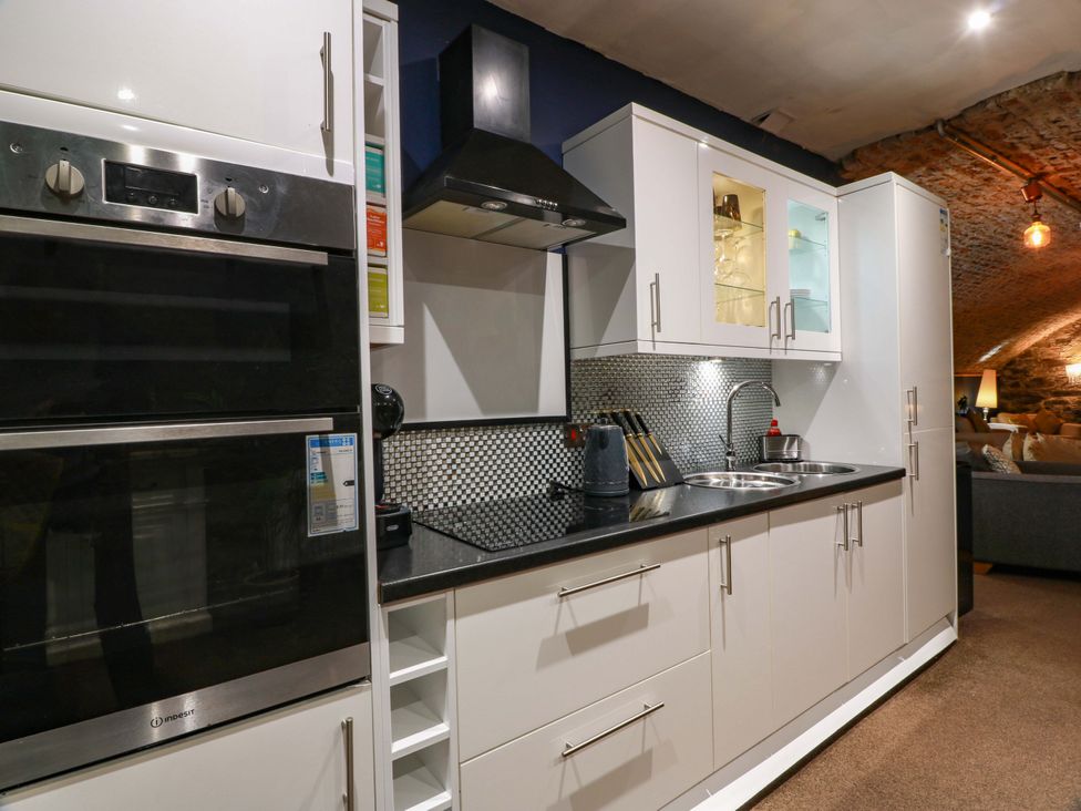A kitchen with appliances and countertop at 69 High Street, Gatehouse Of Fleet