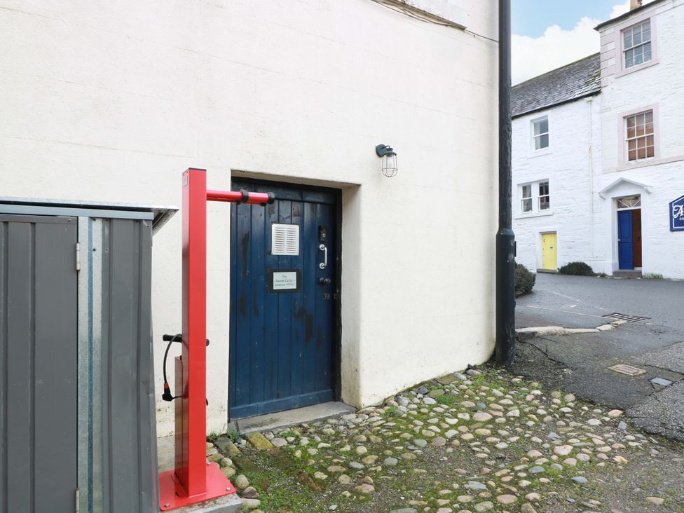 An outdoor area with a blue door and storage shed at 69 High Street Gatehouse Of Fleet
