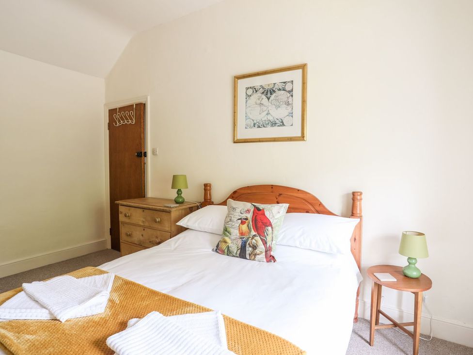 A bedroom with a bed and nightstand at Llys Elen in Caernarfon