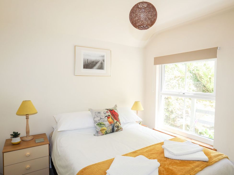 A bedroom with a bed and bedside table at Llys Elen in Caernarfon