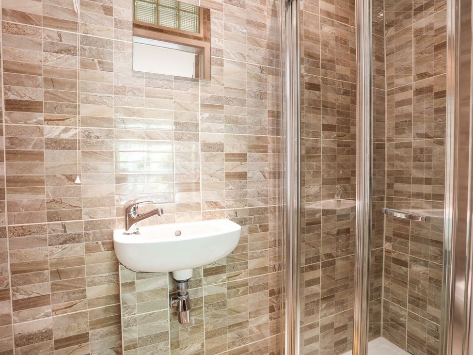 A bathroom with a sink and shower at Llys Elen in Caernarfon