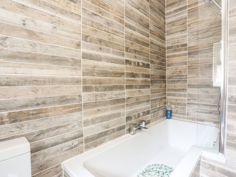 A bathroom with a bathtub and shower at Llys Elen in Caernarfon