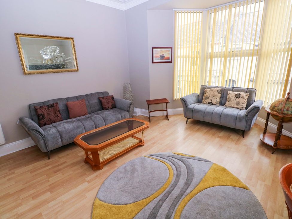 A living room with sofas and a coffee table at 1 Hilton Flats in Tenby