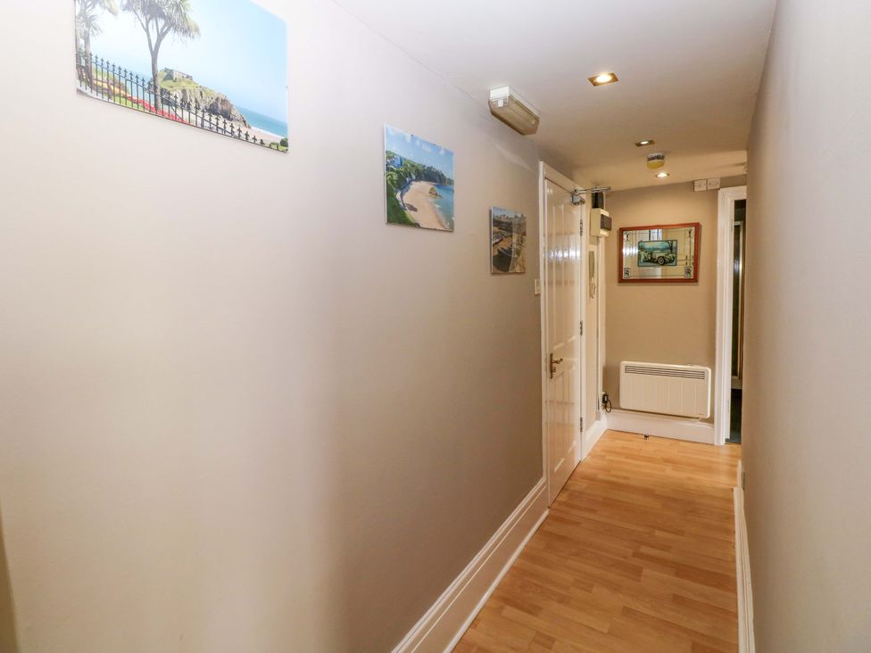 A hallway with pictures on the wall at 1 Hilton Flats in Tenby