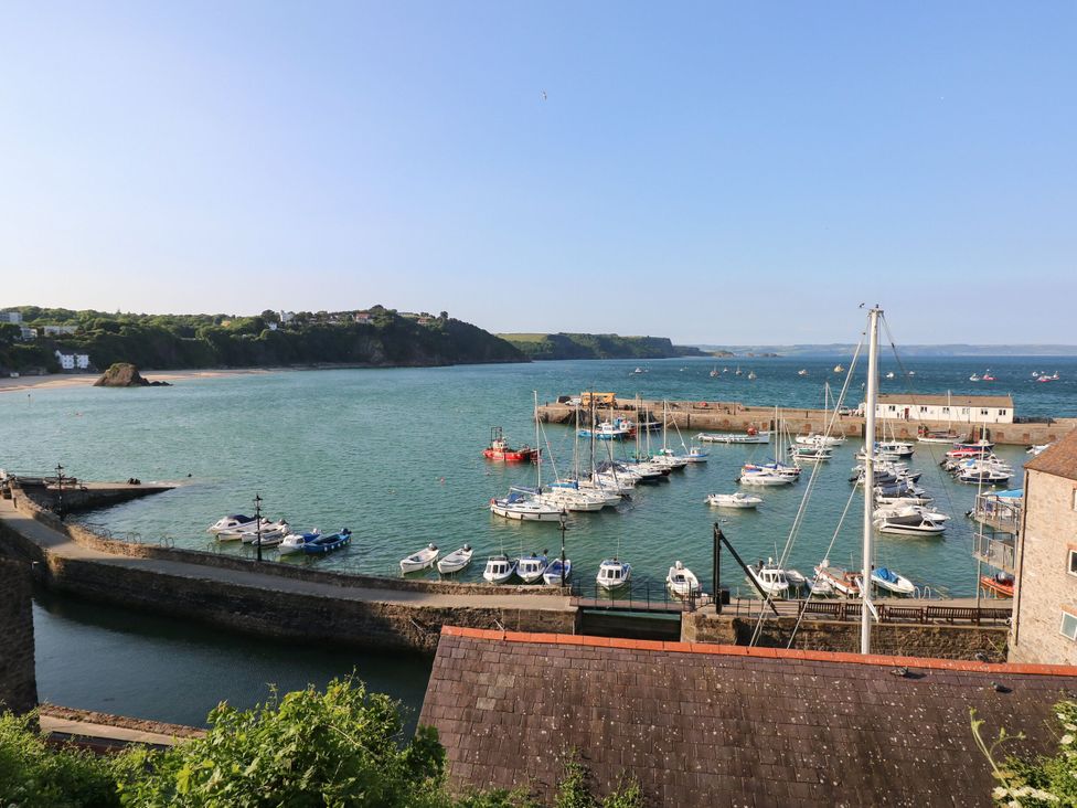 A harbor with boats and a view of the coastline at 1 Hilton Flats Tenby