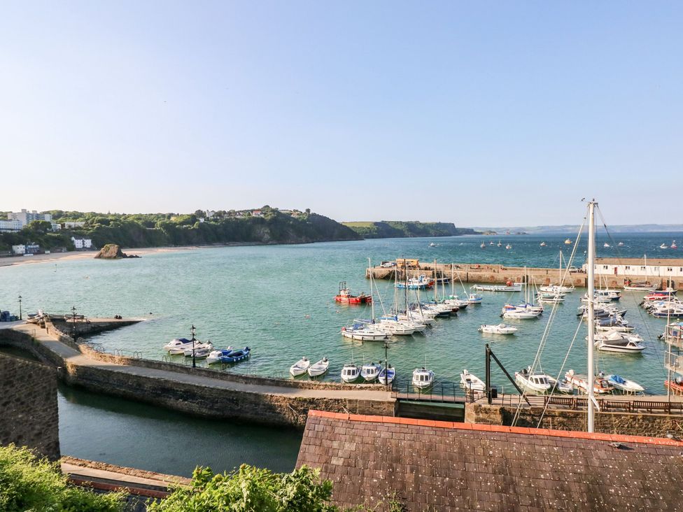 A marina with boats and a coastline at 1 Hilton Flats in Tenby