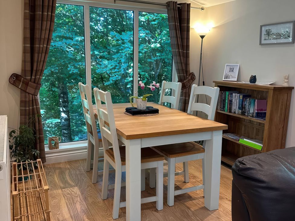 A dining room with a table and chairs at Owls House - White Cross Bay Windermere