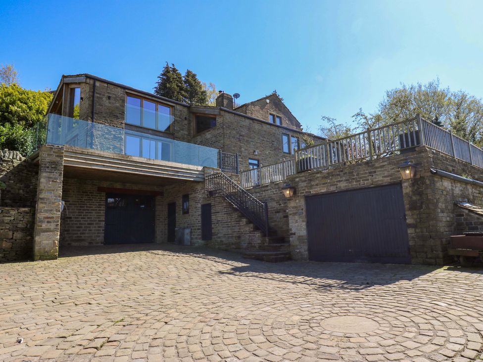 A house with a garage and balcony at Rocks Cottage Halifax