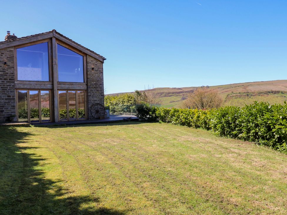 A house with large windows overlooking green fields at Rocks Cottage Halifax