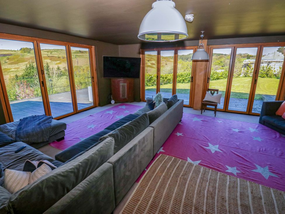 A living room with a sofa and television at Rocks Cottage Halifax