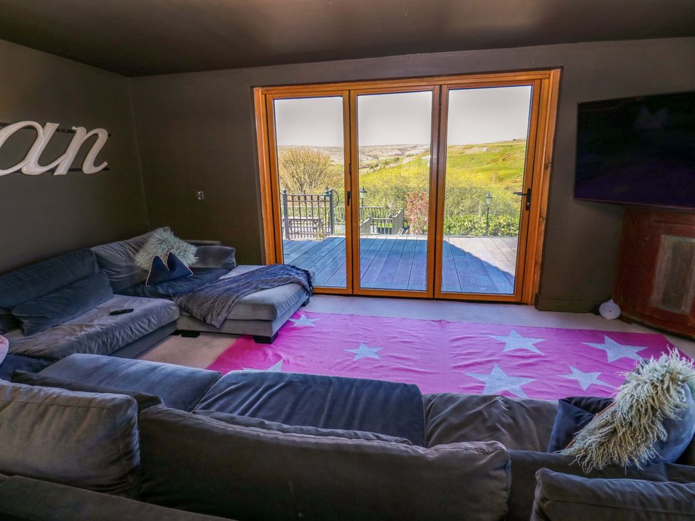 A living room with a sofa and sliding doors at Rocks Cottage Halifax