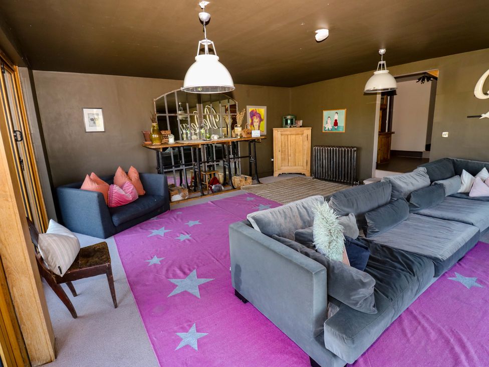 A living room with a sofa and table at Rocks Cottage Halifax