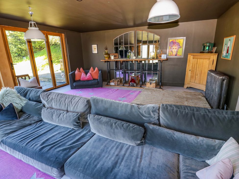 A living room with a sofa and dining table at Rocks Cottage Halifax