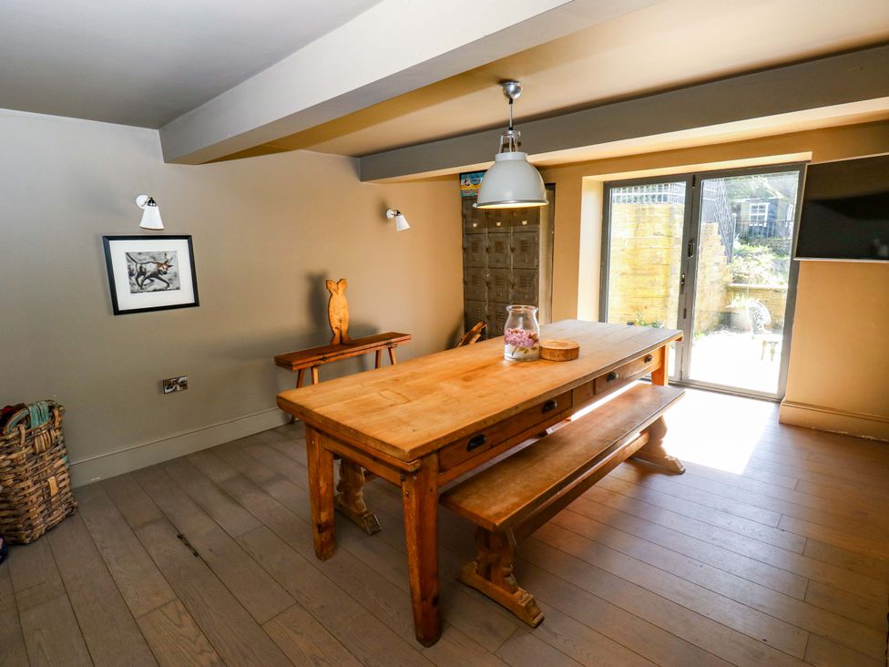 A dining room with a table and benches at Rocks Cottage in Halifax