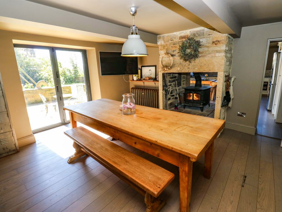 A dining room with a table and benches at Rocks Cottage Halifax