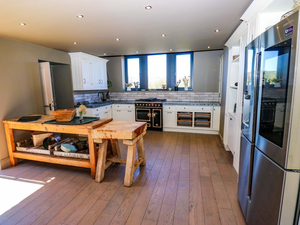 A kitchen with an island and appliances at Rocks Cottage in Halifax