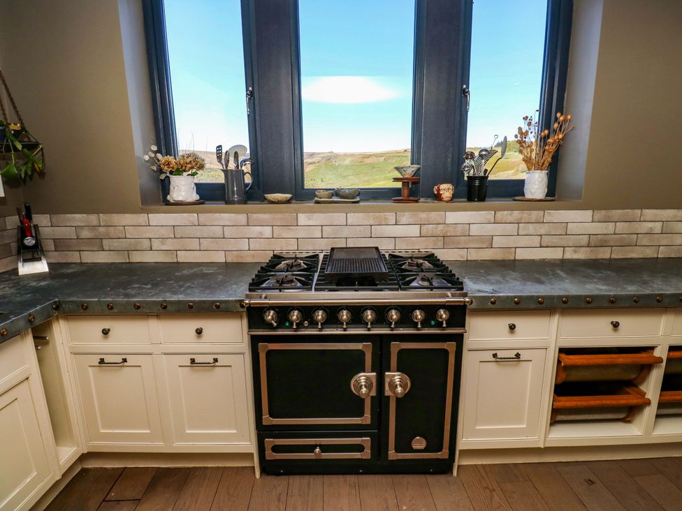 A kitchen with a stove and window at Rocks Cottage Halifax
