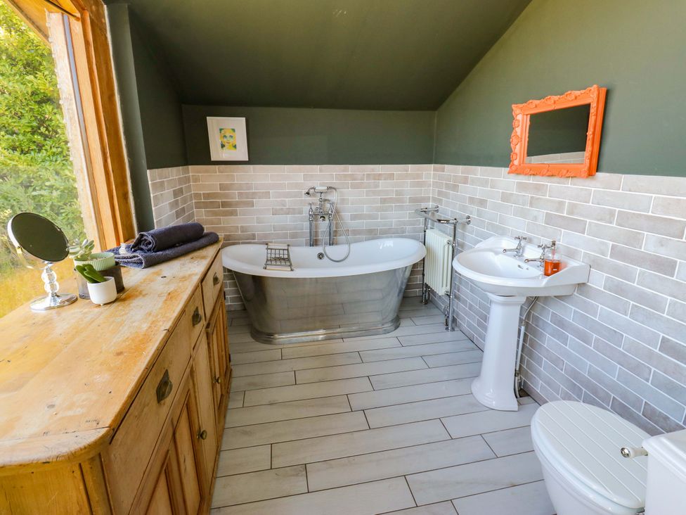 A bathroom with a bathtub and sink at Rocks Cottage Halifax