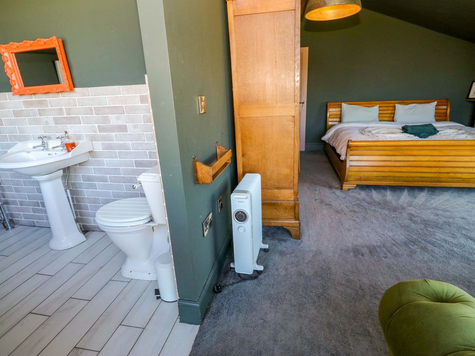 A bedroom with a bed and a sink at Rocks Cottage in Halifax