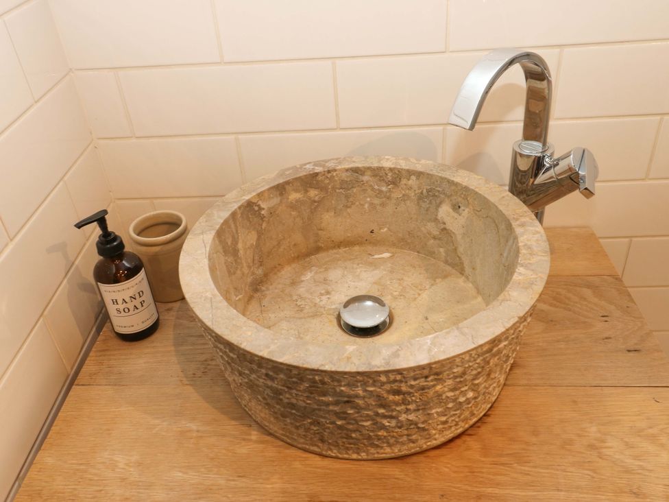 A sink with a faucet and soap dispenser at Rocks Cottage Halifax