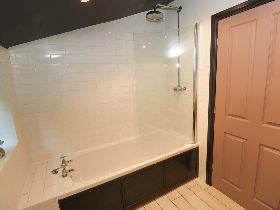 A bathroom with a bathtub and shower at Rocks Cottage Halifax