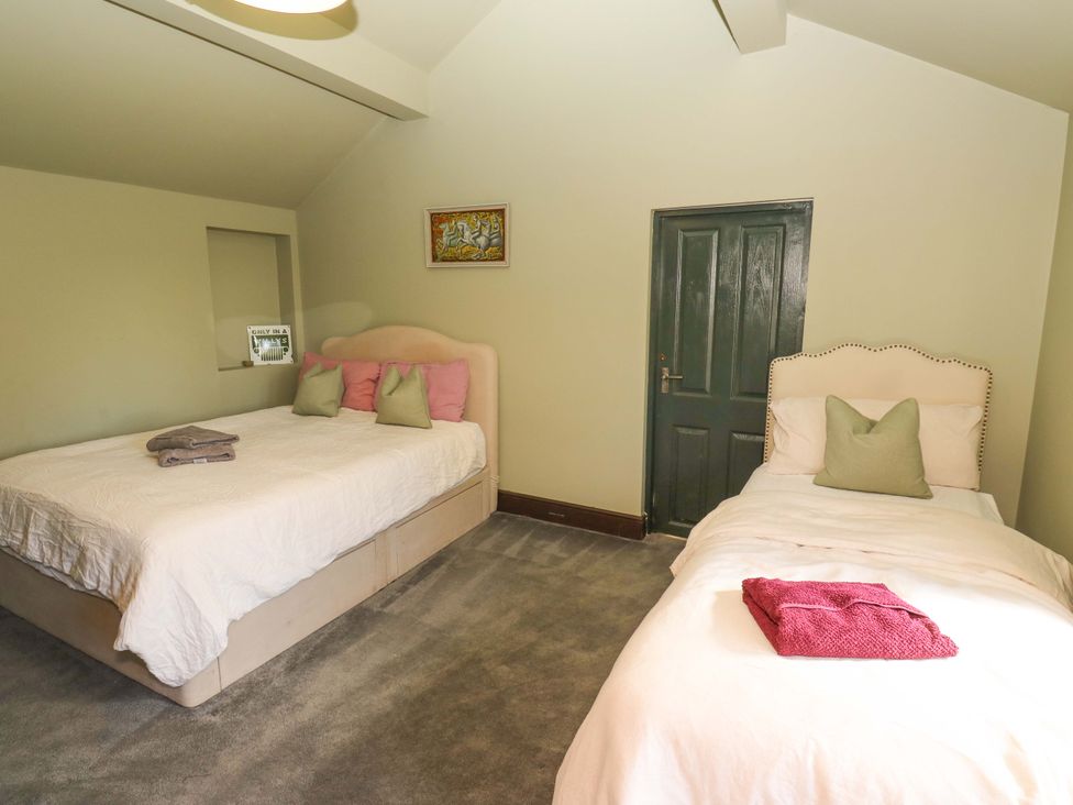 A bedroom with two beds and a door at Rocks Cottage in Halifax