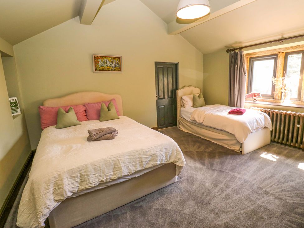 A bedroom with two beds and a window at Rocks Cottage in Halifax