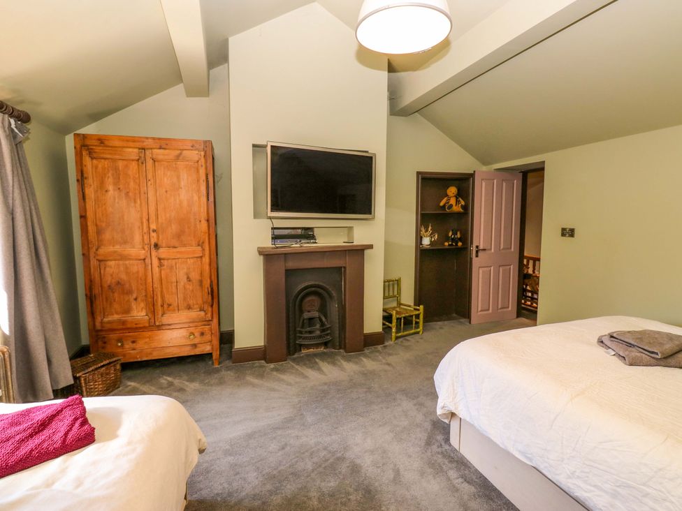 A bedroom with wardrobe and television at Rocks Cottage Halifax