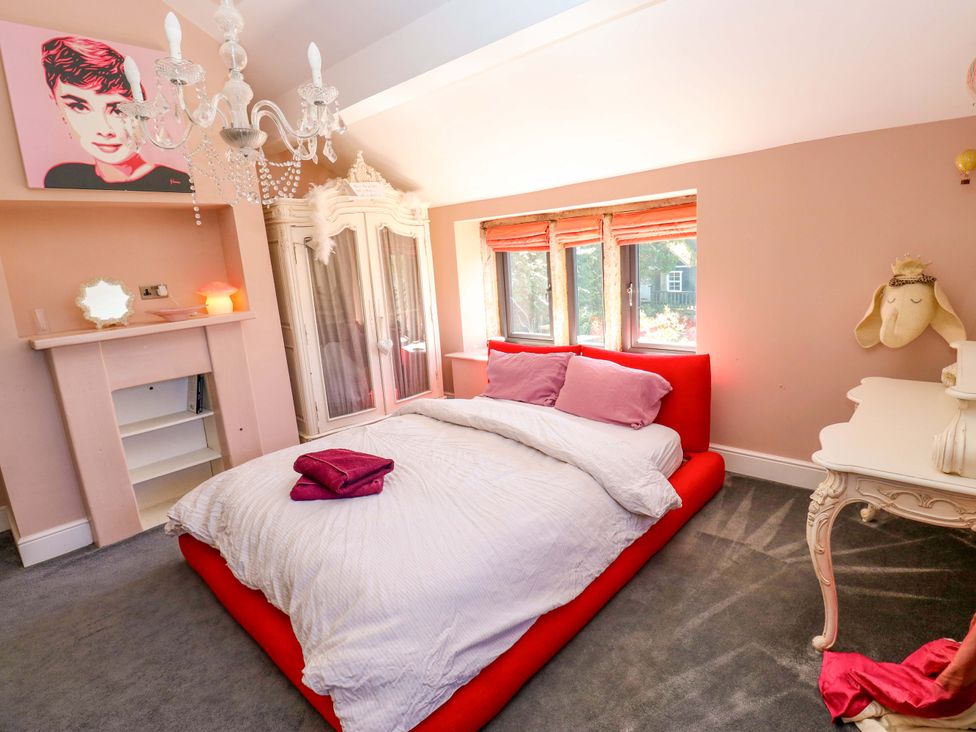 A bedroom with a bed and wardrobe at Rocks Cottage Halifax