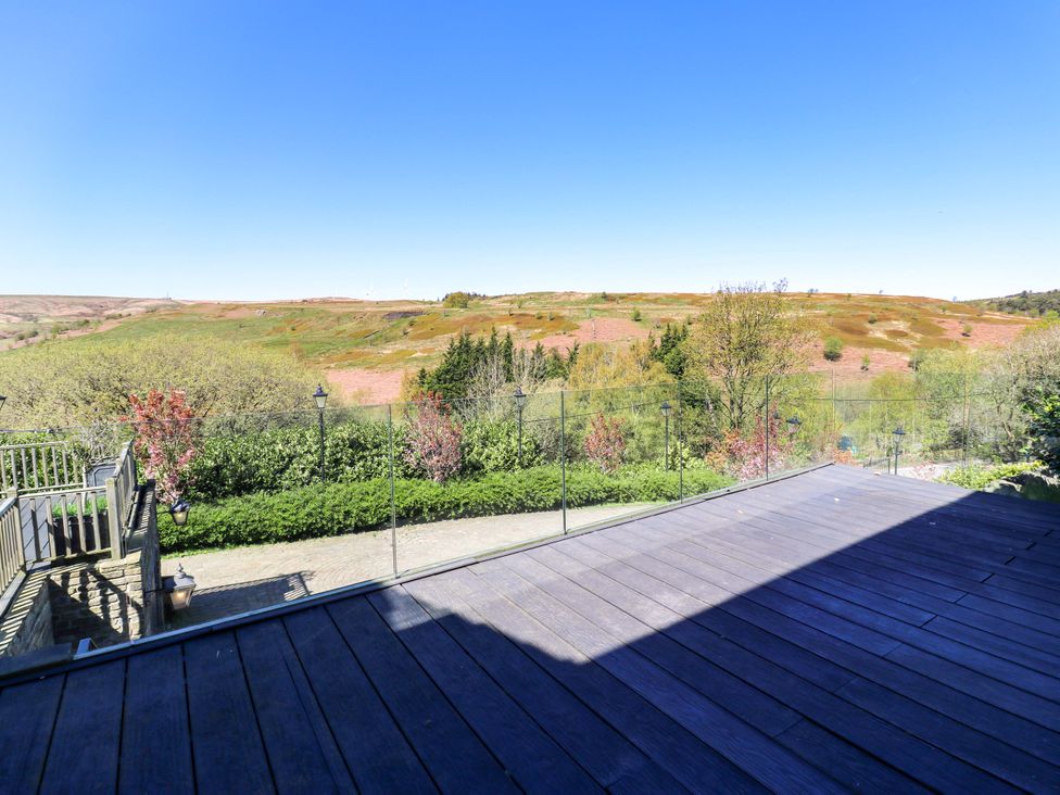 A deck overlooking a landscaped area at Rocks Cottage Halifax
