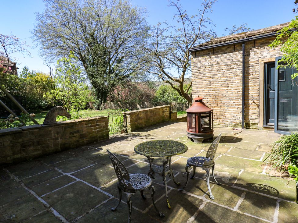 An outdoor patio with a table and chairs at Rocks Cottage in Halifax