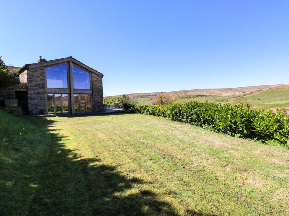 A house with large windows and a garden at Rocks Cottage Halifax