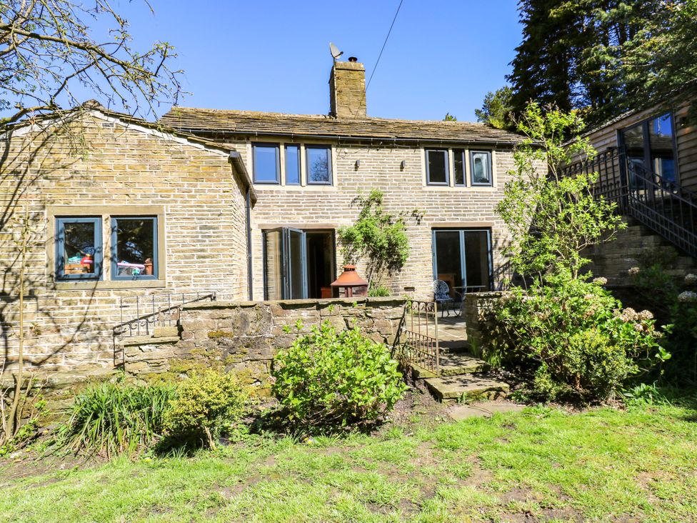 A house exterior with garden and seating area at Rocks Cottage Halifax