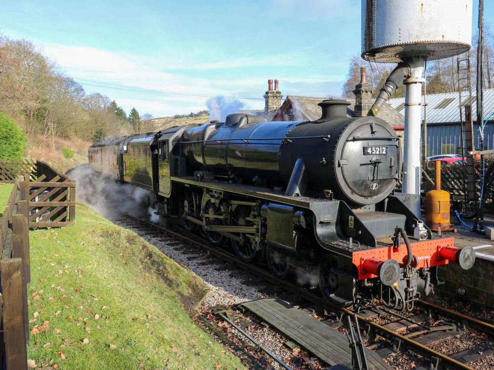 A steam locomotive and train carriage at a station near Halifax