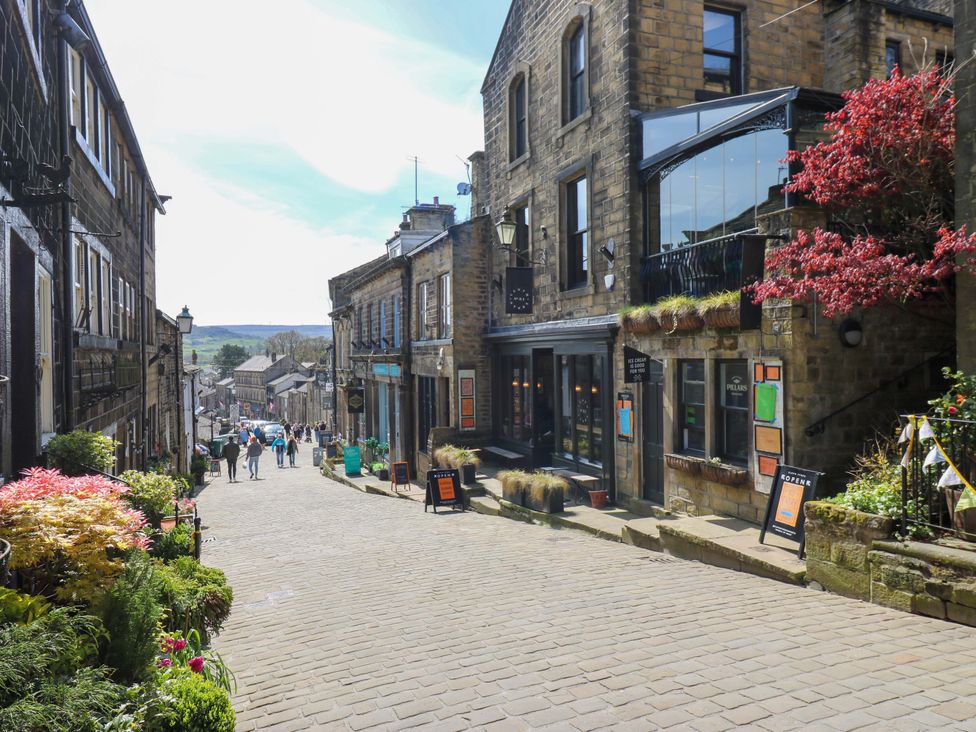 A cobblestone street lined with buildings and shops at Rocks Cottage in Halifax