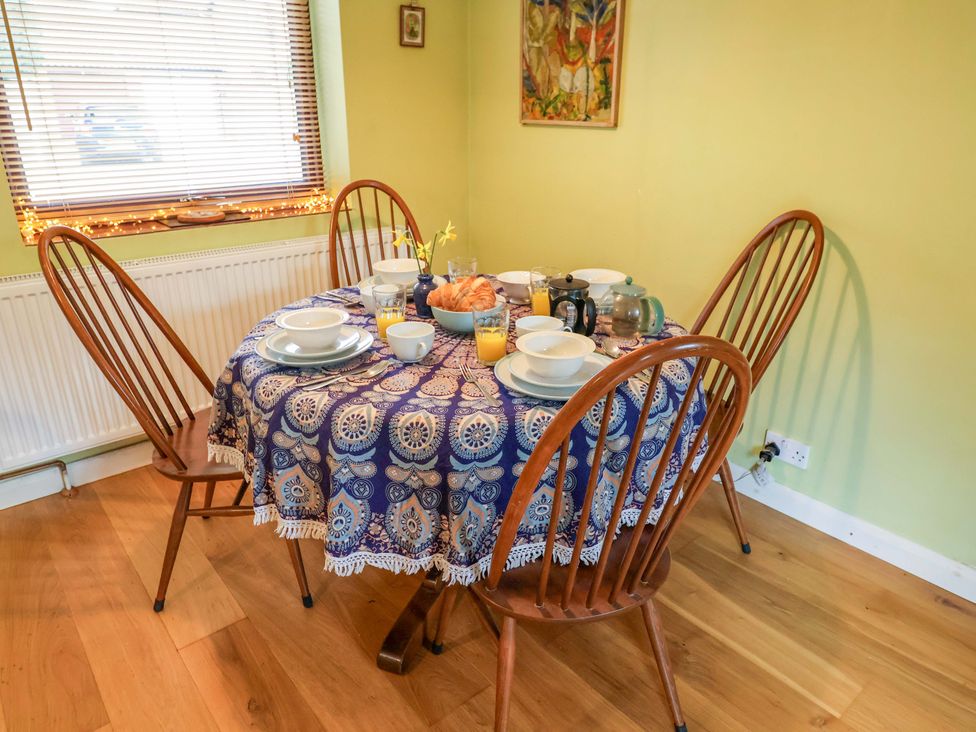A dining room with a table set for breakfast at 17 Demesne Gardens, Ipswich