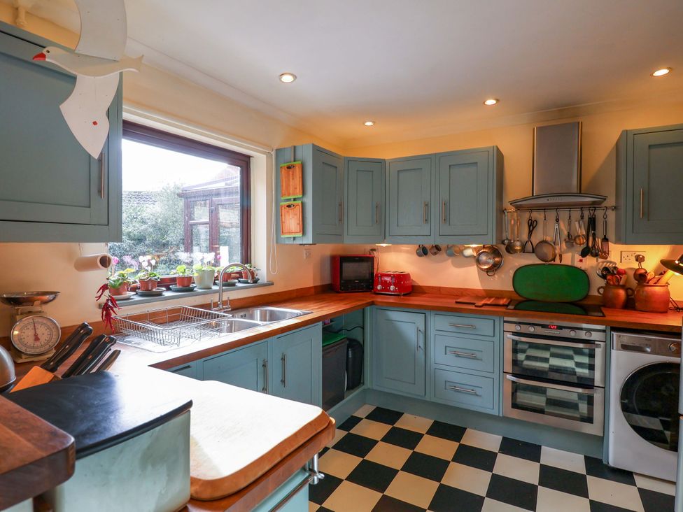 A kitchen with cabinets and appliances at 17 Demesne Gardens Ipswich