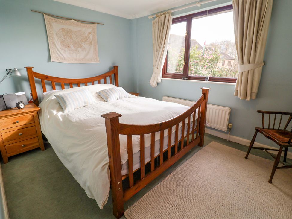A bedroom with a bed and bedside table at 17 Demesne Gardens in Ipswich
