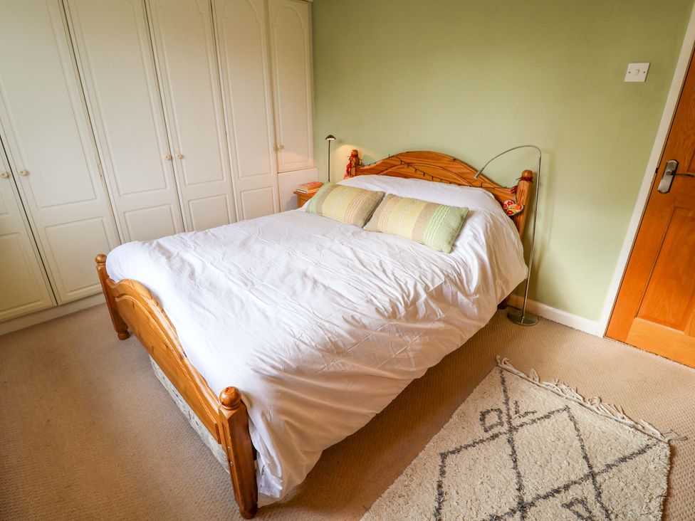 A bedroom with a bed and wardrobe at 17 Demesne Gardens Ipswich