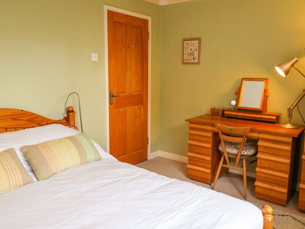 A bedroom with a bed and a desk at 17 Demesne Gardens in Ipswich