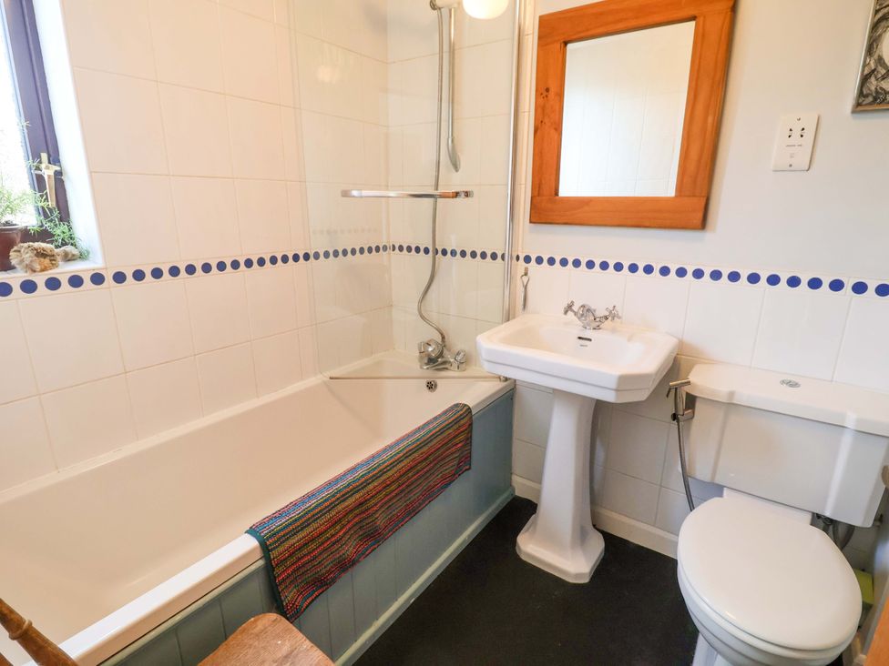 A bathroom with a bathtub and sink at 17 Demesne Gardens Ipswich