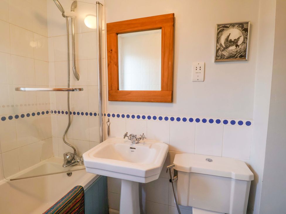A bathroom with a shower, bathtub, sink, and toilet at 17 Demesne Gardens, Ipswich