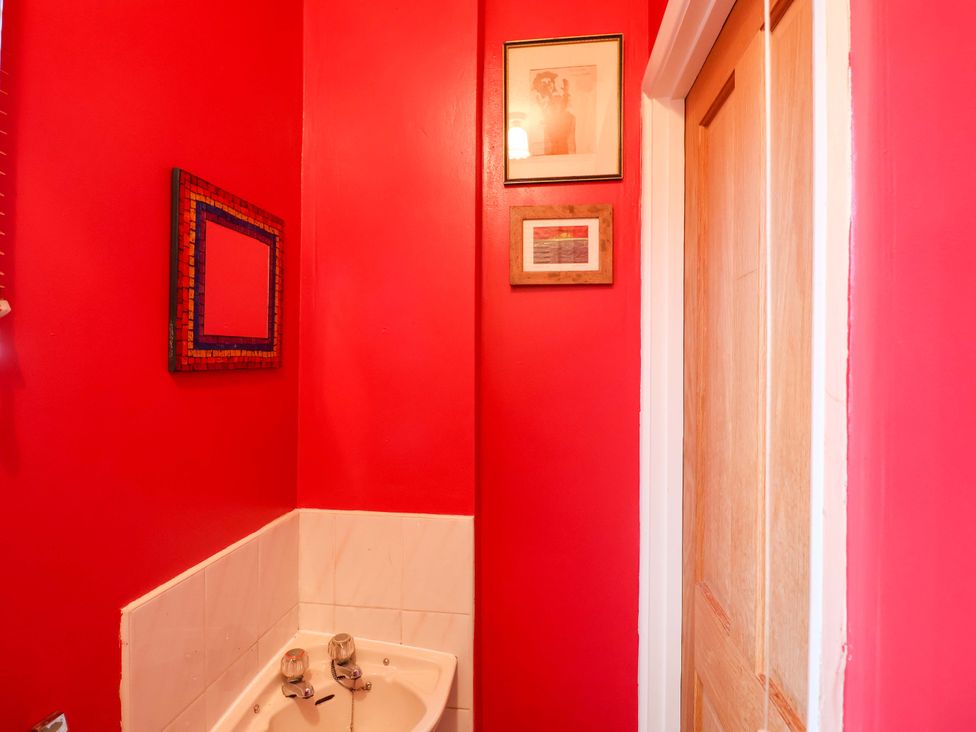 A bathroom with a sink and decorative frames at 17 Demesne Gardens Ipswich